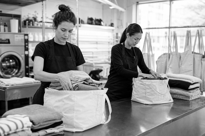 Representative modern wash-and-fold team preparing customer orders