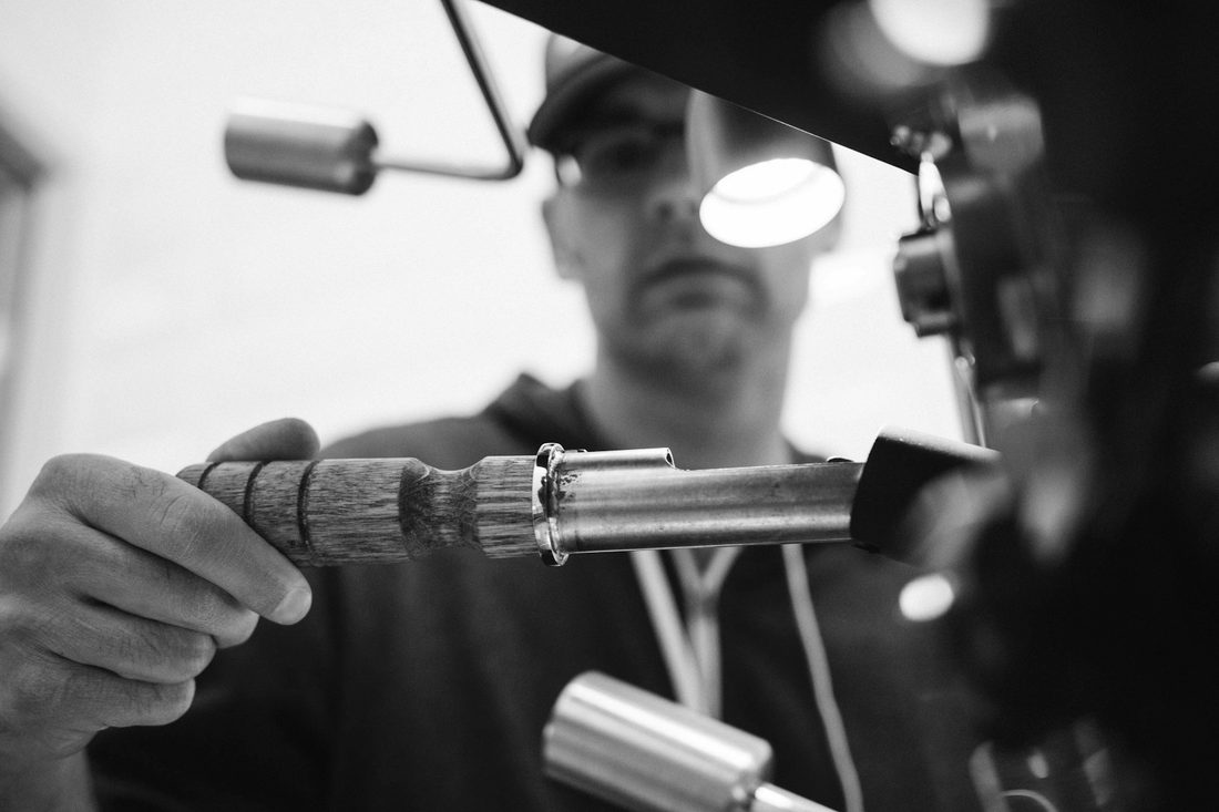 Garment-care specialist pressing a shirt