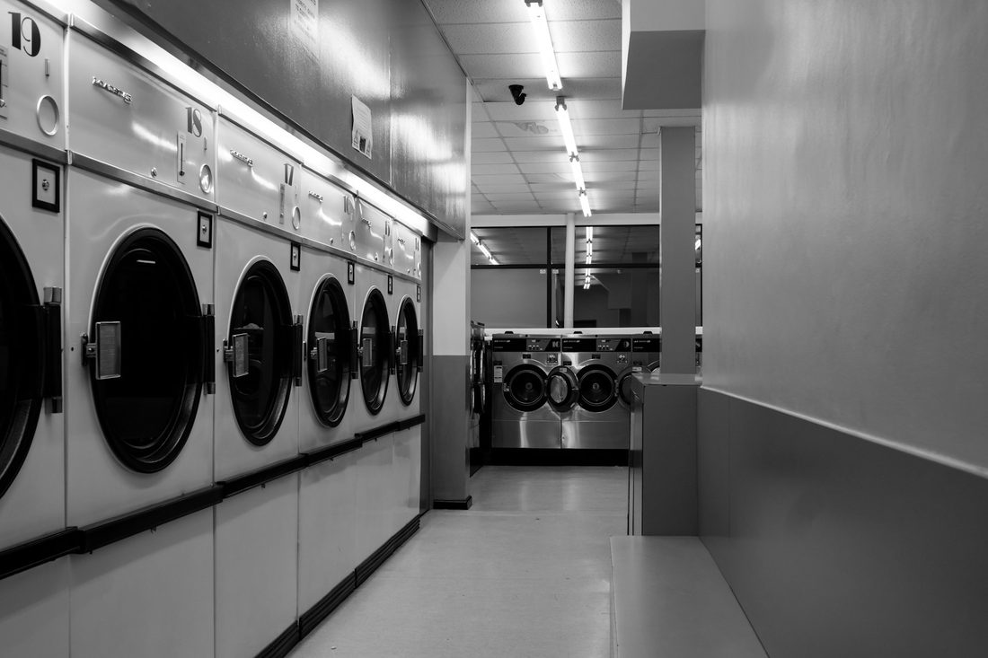 Rows of machines inside a self-service laundromat