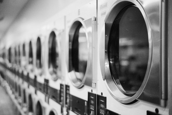 Row of washing machines in a working laundromat